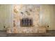 Stone fireplace with metal screen is surrounded by wood paneling at 106 Banyan Dr, Ormond Beach, FL 32176