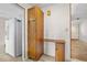 Hallway with desk and white appliances adjacent to a bright white painted wall at 106 Banyan Dr, Ormond Beach, FL 32176