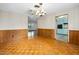 Living room with stylish light fixture and doorway leading to kitchen area at 106 Banyan Dr, Ormond Beach, FL 32176