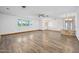 Expansive living area featuring light walls, wood-look floors, and chandelier lighting at 106 Banyan Dr, Ormond Beach, FL 32176