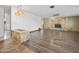 Open concept living room featuring stone fireplace, hardwood floors, and chandelier lighting at 106 Banyan Dr, Ormond Beach, FL 32176