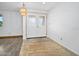 Bright room featuring elegant double doors, sleek hardwood flooring and natural light at 106 Banyan Dr, Ormond Beach, FL 32176