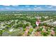 A beautiful aerial view showcases the neighborhood's lush landscaping, winding streets, and scenic pond at 12 Big Buck Trl, Ormond Beach, FL 32174