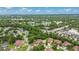 Aerial view of community with lake, tennis court, pool and lush green surroundings at 12 Big Buck Trl, Ormond Beach, FL 32174
