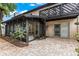 An inviting outdoor living space features a brick patio, screened enclosure, and a cozy upper deck at 12 Big Buck Trl, Ormond Beach, FL 32174