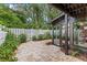 A brick-paved patio offers a serene outdoor retreat with a glimpse of the home's screened-in porch at 12 Big Buck Trl, Ormond Beach, FL 32174