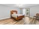 Bedroom featuring wood-look floors, a ceiling fan, and access to the outdoors via a glass door at 12 Big Buck Trl, Ormond Beach, FL 32174