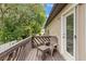 Relaxing deck space with a chair and table, perfect for enjoying the surrounding lush greenery at 12 Big Buck Trl, Ormond Beach, FL 32174