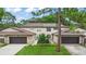 Charming townhome featuring an attached garage, well-maintained lawn, and beautiful landscaping at 12 Big Buck Trl, Ormond Beach, FL 32174