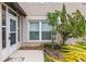 A well-manicured front entrance welcomes you with lush greenery and a charming covered doorway at 12 Big Buck Trl, Ormond Beach, FL 32174