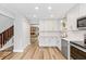 Bright kitchen features white cabinetry, modern appliances, and a stylish backsplash at 12 Big Buck Trl, Ormond Beach, FL 32174