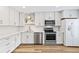 Modern kitchen featuring stainless steel appliances, white cabinetry, and quartz countertops at 12 Big Buck Trl, Ormond Beach, FL 32174