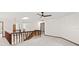Spacious upstairs landing with wood railing and neutral carpet at 12 Big Buck Trl, Ormond Beach, FL 32174
