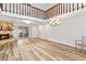 Open living room with stone fireplace, high ceilings, and wood-look flooring at 12 Big Buck Trl, Ormond Beach, FL 32174