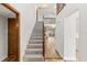 Inviting staircase with wood railing, carpet steps, and open access to the living area at 12 Big Buck Trl, Ormond Beach, FL 32174