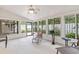 Bright sunroom surrounded by windows, offering views of the landscaped backyard at 12 Big Buck Trl, Ormond Beach, FL 32174