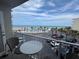 Charming balcony view showcasing the pool, palm trees, beach and ocean under a beautiful partly cloudy blue sky at 1233 S Atlantic Ave # 3070, Daytona Beach, FL 32118