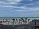 Relaxing view showcasing the pool, palm trees, beach and ocean under a beautiful partly cloudy blue sky at 1233 S Atlantic Ave # 3070, Daytona Beach, FL 32118