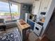 Kitchen features partial ocean views, a portable island, and modern white and blue cabinets at 1233 S Atlantic Ave # 3070, Daytona Beach, FL 32118