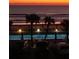 Ocean view with palm trees and pool at nightfall, silhouetted against the sky at 1233 S Atlantic Ave # 3070, Daytona Beach, FL 32118