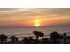 Tropical sunrise at the beach with silhouetted palm trees on the sand at 1233 S Atlantic Ave # 3070, Daytona Beach, FL 32118