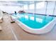 Indoor pool with pristine blue water, accessible by a metal handrail at 1233 S Atlantic Ave # 3070, Daytona Beach, FL 32118