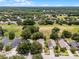 Aerial shot showcasing the property's location with mature trees and proximity to lush green spaces at 25216 Ironwedge Dr, Sorrento, FL 32776