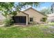 Well-maintained backyard showing the back of the house, lush landscaping, and an outdoor space at 25216 Ironwedge Dr, Sorrento, FL 32776