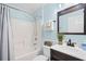 Clean bathroom featuring a shower-tub combo, updated vanity, and modern fixtures at 25216 Ironwedge Dr, Sorrento, FL 32776