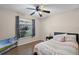 Bright bedroom with wood floors, large window, and stylish decor at 25216 Ironwedge Dr, Sorrento, FL 32776