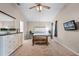 Inviting bedroom featuring a large dresser, stylish nightstand, and television mounted on the wall at 25216 Ironwedge Dr, Sorrento, FL 32776