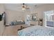 Bright bedroom with a seating area and a view into an en-suite bathroom and out to an adjacent room at 25216 Ironwedge Dr, Sorrento, FL 32776