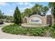 Entrance sign for Fairways at Mount Plymouth featuring well-maintained landscaping and mature trees at 25216 Ironwedge Dr, Sorrento, FL 32776