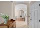 Inviting foyer with neutral tones, tiled floors, and an arched entryway leading to the dining area at 25216 Ironwedge Dr, Sorrento, FL 32776