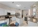 Spacious kitchen with white cabinets, granite countertops, stainless steel appliances, and an island at 25216 Ironwedge Dr, Sorrento, FL 32776