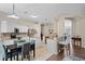Bright kitchen and dining area with white cabinets, stainless steel appliances, and tiled floors at 25216 Ironwedge Dr, Sorrento, FL 32776