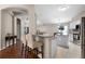 Open kitchen features granite countertops, stainless steel appliances, and breakfast bar seating at 25216 Ironwedge Dr, Sorrento, FL 32776