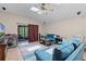 Inviting living room with vaulted ceiling, wood-look floors, and access to outdoor patio at 25216 Ironwedge Dr, Sorrento, FL 32776