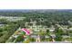 Aerial view shows the home with a screened pool and a fenced back yard in a suburban setting at 321 Scotland Dr, Daytona Beach, FL 32117