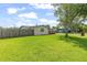 Backyard features mature trees, lush green grass, and a wooden fence at 321 Scotland Dr, Daytona Beach, FL 32117