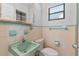Retro bathroom featuring a green sink and matching vintage tile at 321 Scotland Dr, Daytona Beach, FL 32117