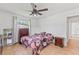 Well-lit bedroom showcases tile flooring, ceiling fan, and tasteful furnishings for comfortable living at 321 Scotland Dr, Daytona Beach, FL 32117
