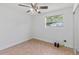 Bright bedroom with tile floors, ceiling fan, and a large window offering ample natural light at 321 Scotland Dr, Daytona Beach, FL 32117