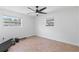 This cozy bedroom features tile flooring, ample natural light, and a ceiling fan for added comfort at 321 Scotland Dr, Daytona Beach, FL 32117