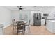 Well-lit dining area featuring a round table, leads to a modern kitchen and a view of the outdoor pool at 321 Scotland Dr, Daytona Beach, FL 32117