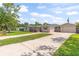 Single-story home with a well-maintained lawn and a long driveway leading to a detached garage at 321 Scotland Dr, Daytona Beach, FL 32117