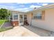 Inviting porch with brick accents, decorative shutters, and a cheerful spring welcome sign at 321 Scotland Dr, Daytona Beach, FL 32117
