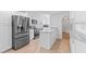 Modern kitchen features white cabinets, stainless steel appliances, and light granite countertops at 321 Scotland Dr, Daytona Beach, FL 32117