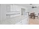 Modern kitchen with white cabinets, granite countertops, and stainless steel appliances at 321 Scotland Dr, Daytona Beach, FL 32117