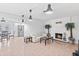 Cozy living room featuring a white brick fireplace, tile floors, and modern pendant lighting at 321 Scotland Dr, Daytona Beach, FL 32117